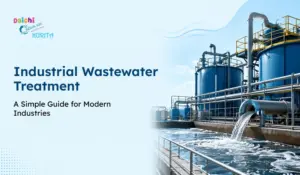 Industrial wastewater treatment plant with large blue tanks, pipes, and water discharge, illustrating modern wastewater treatment for industries.